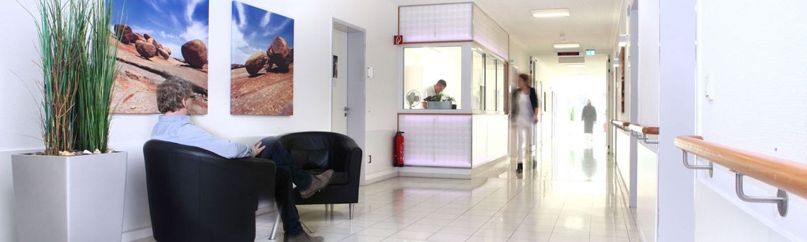View of the urology ward in Gronau with a patient waiting in the background and staff walking by
