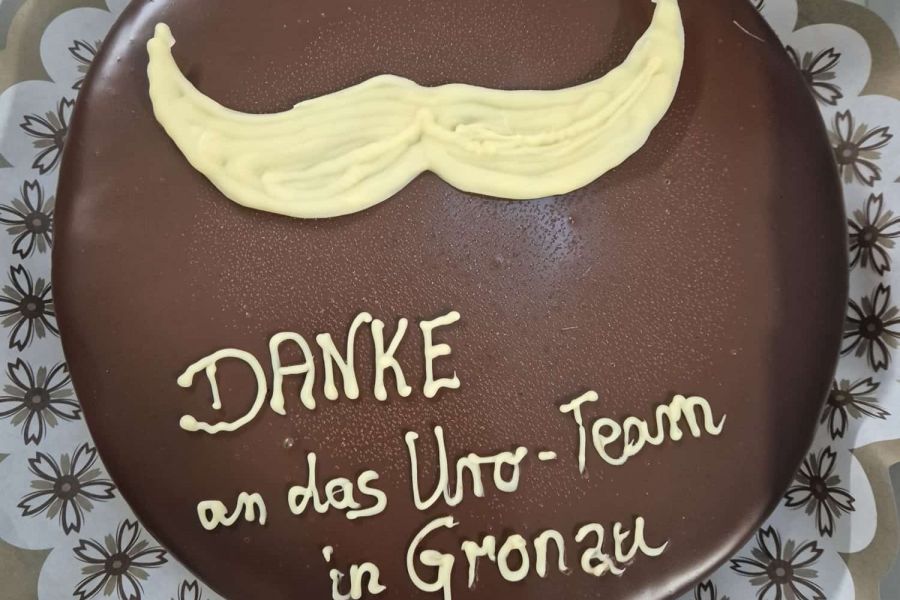 Herrentorte mit Glasur-Aufschrift: Danke an das Uro-Team in Gronau plus Moustache-Zeichen. 